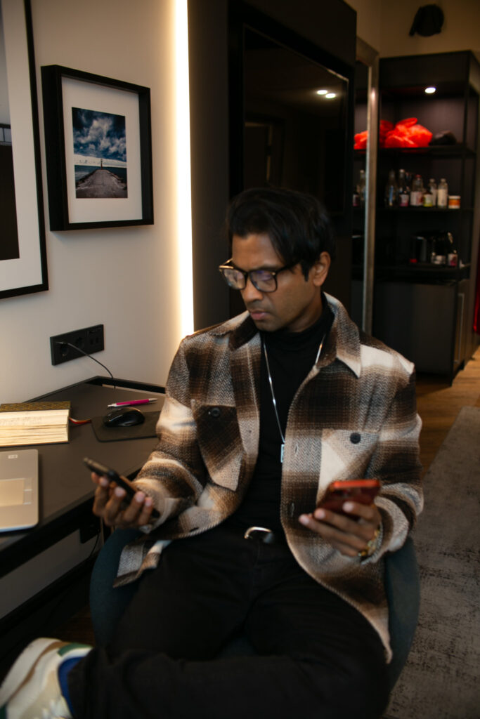 Fernando-Raymond-Looking-at-his-Mobile-phone-while-in-Radisson-Collection-Hotel-in-Tallinn-Estonia