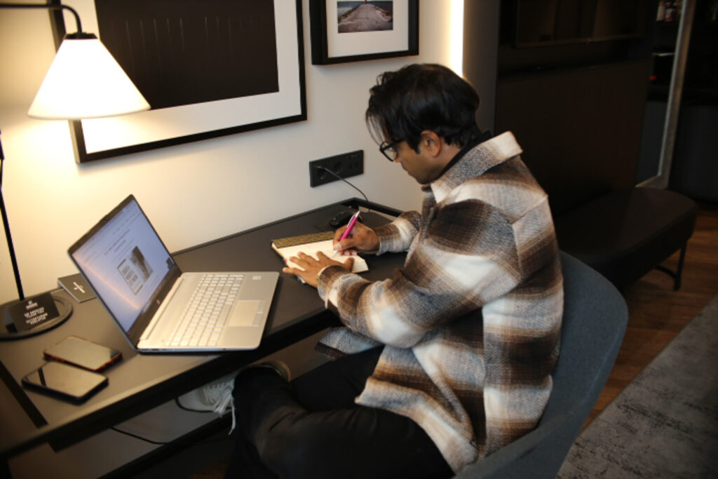 Fernando-Raymond-Working-on-his-Laptop-from-Radisson-Collection-Hotel-in-Tallinn-Estonia